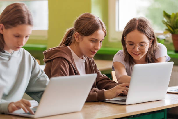 istock Teenage girls using laptops in the classroom 1513743682