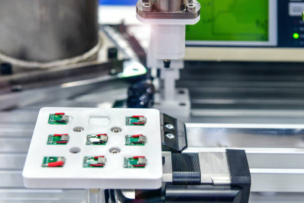 istock Factory machinery at work, A small printed circuit board is assembled into an automated robotic arm. 1513747127