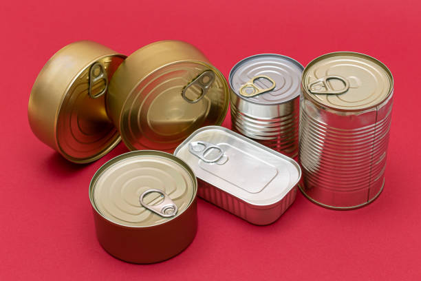 istock Unopened Tin Cans with Blank Edges on Red Background 1513759289