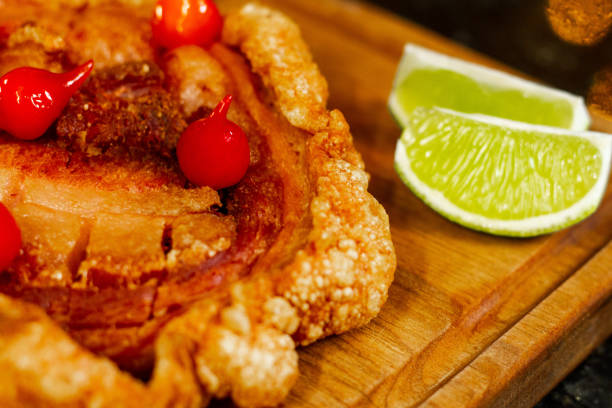 Indulge in the irresistible combination of crispy pork roulade and tangy pepper jam at our vibrant nighttime bar. Savor the savory flavors and contrasting textures of this mouthwatering dish. A perfect blend of indulgence and spice awaits you in this tempting treat. Get ready for a culinary delight that will leave you craving for more.