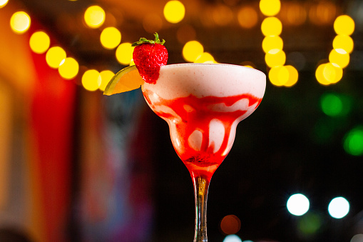 Strawberry Smoothie at a vibrant night bar. Savor the refreshing blend of luscious strawberries, orange and creamy goodness, and a hint of sweetness.