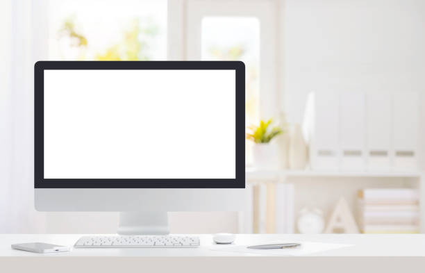 istock Computer monitor with white screen on desk in modern office 1513772277
