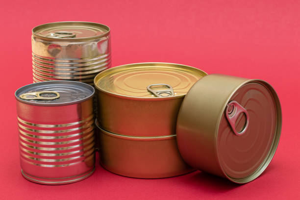 istock Unopened Tin Cans with Blank Edges on Red Background 1513780000