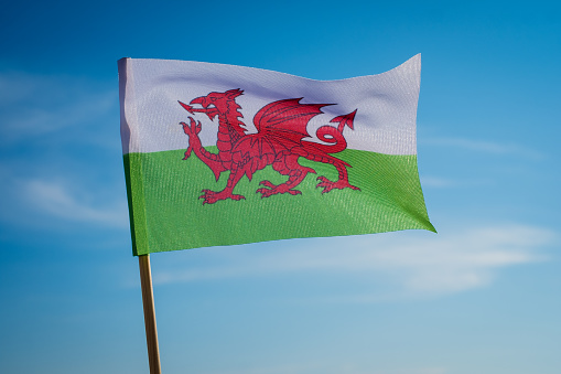 Flag of Wales on blue sky background.