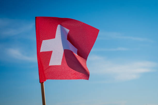 istock Flag of Switzerland on blue sky background. 1513780577