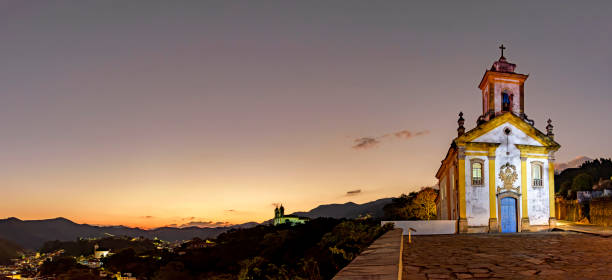 istock Panoramic image with the baroque style churches and the city illuminated 1513781156