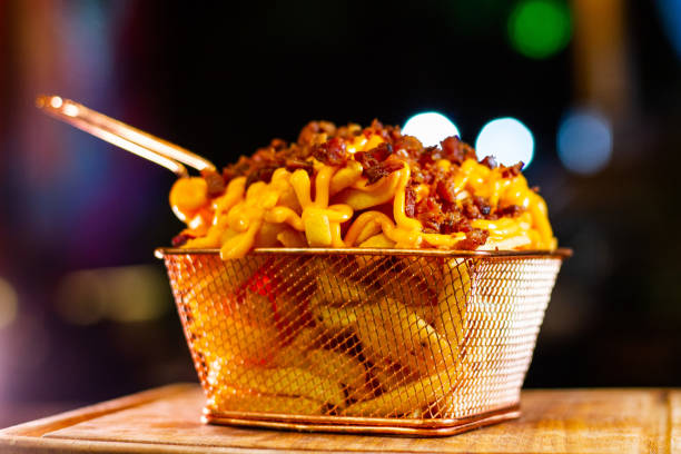 Crispy Bacon Cheddar Fries Experience a tantalizing symphony of flavors with our irresistible golden fries topped with gooey cheddar cheese and crispy bacon. Indulge in the perfect blend of savory and salty, as each bite delivers a mouthwatering explosion of taste. Served in a vibrant bar atmosphere, these fries are the ultimate accompaniment to your night out. Get ready to satisfy your cravings and elevate your bar experience! cheddar gorge stock pictures, royalty-free photos & images