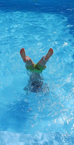 istock Child playing in a pool in summer 1513808385