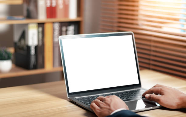 istock Mockup of man using and typing on laptop with blank white desktop screen. 1513826240