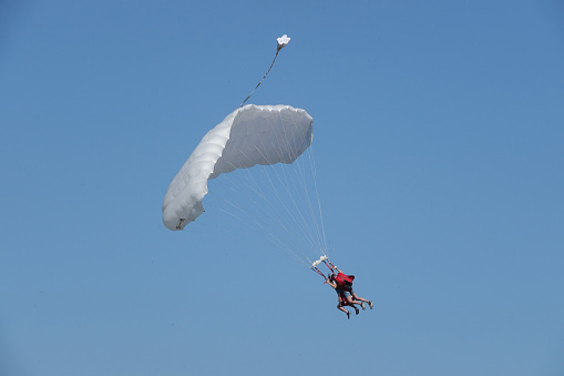 Netherlands. Texel. June 25. 2023. Tourist with instructor has jumped from the aircraft for parasailing