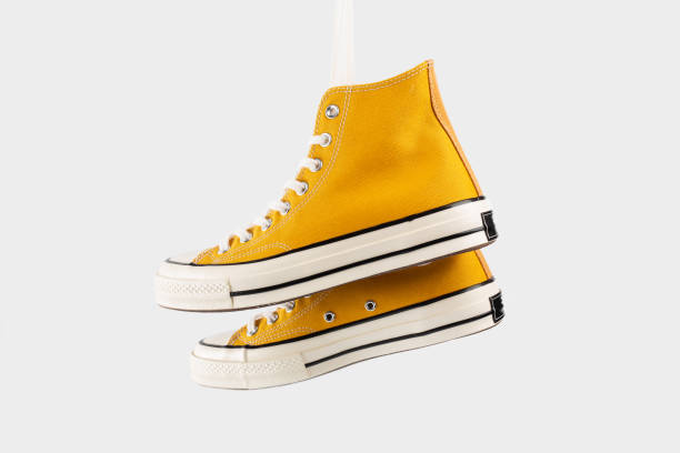 istock Yellow sneakers on white background with copy space. Youth shoes. 1513881085