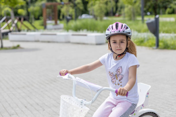 istock Child wearing a helmet riding a bicycle 1513886951