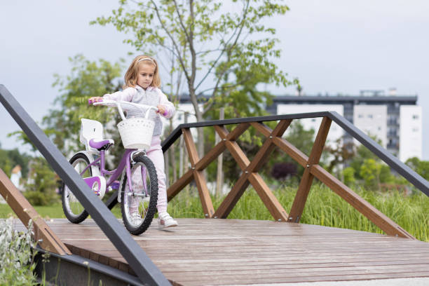 istock Girl pushing bicycle 1513886956