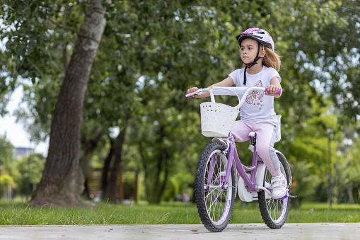 Girl riding bicycle in a park