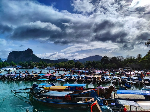 This captivating photo showcases the serene beauty of Aonang Port, nestled along the picturesque coastline of Thailand. The photo captures the tranquil waters of the harbor, reflecting the vibrant hues of the sky and surrounding landscapes. Boats gently sway on the shimmering surface, creating a sense of peace and maritime charm. The port serves as a gateway to adventure, with boats ready to embark on journeys to nearby islands and hidden coves. This photo invites viewers to embrace the serenity and the boundless possibilities that await at Aonang Port.