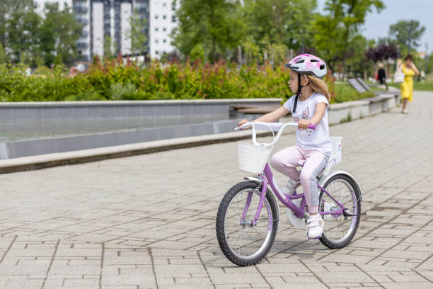 istock Girl riding bicycle in a park 1513890825