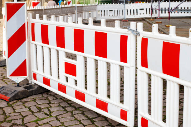 istock white-red fence during repair work 1513898504