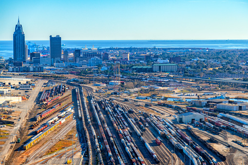 An Aerial View of an Antique Steam Freight Passenger Train Blowing Smoke as it Slowly Travels on an Autumn Day