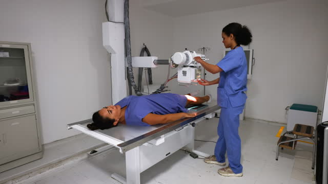 Latin American female patient getting an x-ray of her leg at the hospital