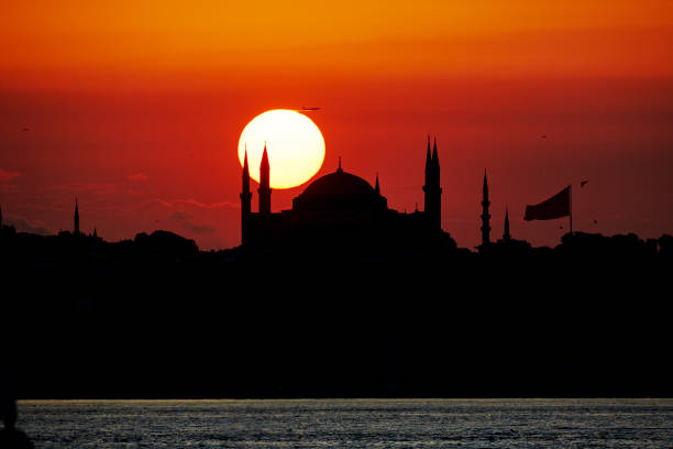 istock sun going down over Hagia Sophia silhouette while an airliner jet taking off 1513930431