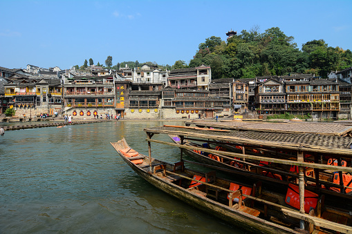 Hunan, China - Nov 6, 2015. Wooden boats on the main canal at Fenghuang Ancient Town, Hunan, China.