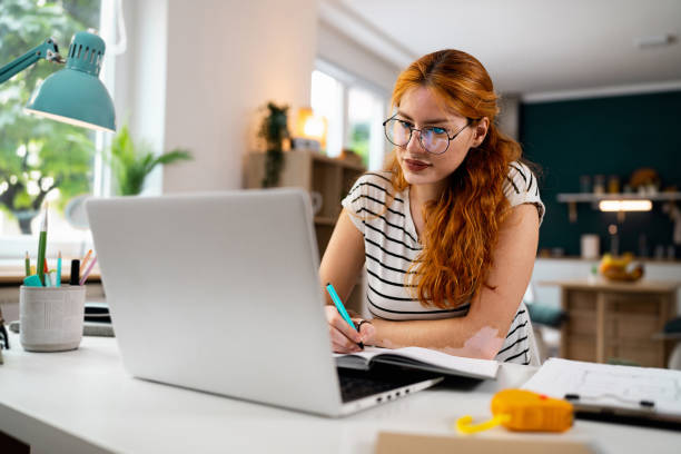 istock Redhead female student with vitiligo and acne on her face, e-learning 1514013843