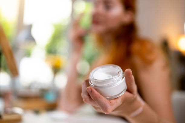 istock Unrecognizable woman with vitiligo holding a face cream 1514026685