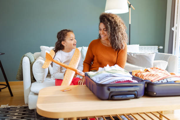 istock Mother and daughter packing for a trip 1514036553