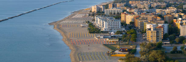 istock Drone view of sandy beach with umbrellas and town background 1514070410