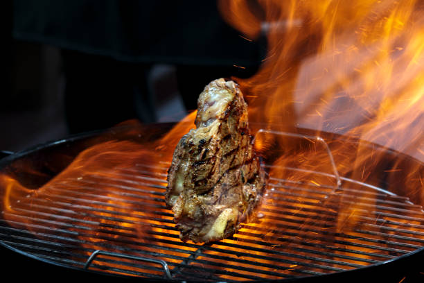 istock Grill steak tomahawk. Angus beef tbone on fire flame 1514072641
