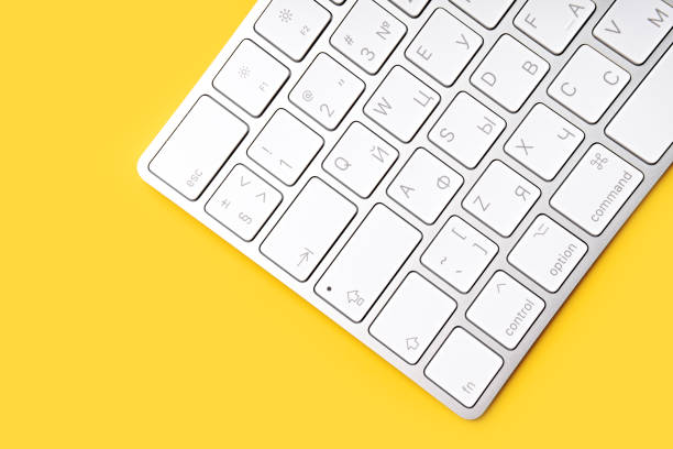 istock Woman Typing On A Keyboard White wireless computer keyboard isolated on white background. Russian / English keyboard layout. 1514078893