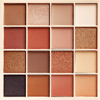 Eyeshadows palette as close up texture background Beauty product cosmetic powder for make up eye, beige brown color scheme, matte and shimmer tints. Aesthetic photo pattern, cosmetics textured fon.