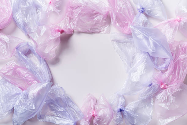 istock Colored used plastic bags flat lay, polyethylene packages on light background. Sustainable lifestyle, plastic free, eco trend to reduce disposable plastic, creative top view frame with copy space 1514081012