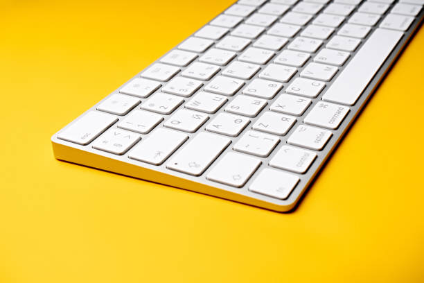 istock Woman Typing On A Keyboard White wireless computer keyboard isolated on white background. Russian / English keyboard layout. 1514084179