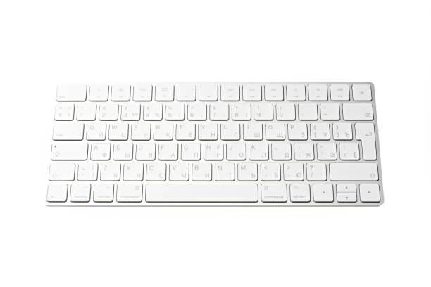 istock Woman Typing On A Keyboard White wireless computer keyboard isolated on white background. Russian / English keyboard layout. 1514084276