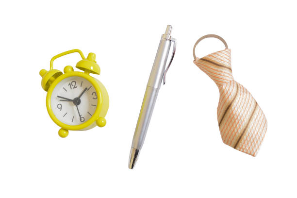 Yellow clock, pen and necktie isolated on a white background.
