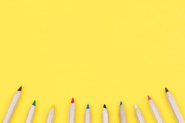 istock Multicolored wooden pencils on a yellow background, flat lay. 1514124442