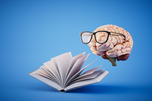 The concept of continuous learning. An open book and a brain with glasses on a blue background. 3D render.