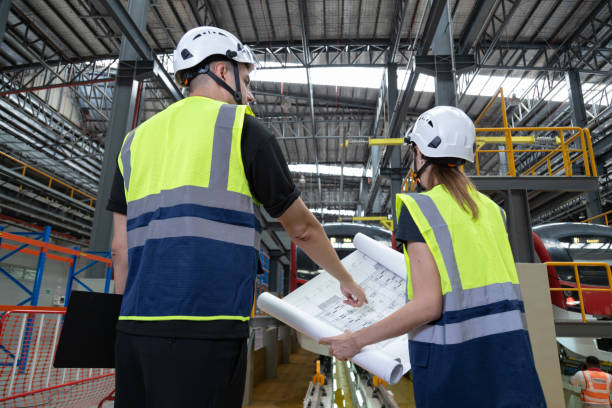 istock Two professional engineers check mechanical check undercarriage of lifted electric train and maintenance of public transport trains in Asia 1514129274