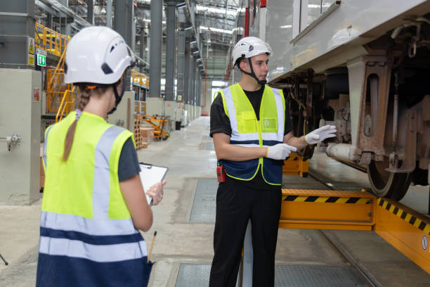 istock Two professional engineers check mechanical check undercarriage of lifted electric train and maintenance of public transport trains in Asia 1514129809