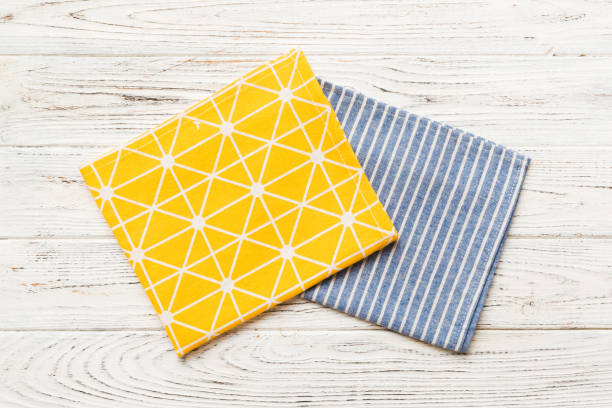 istock top view with yellow empty kitchen napkin isolated on table background. Folded cloth for mockup with copy space, Flat lay. Minimal style 1514134620