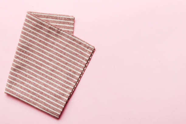 istock top view with red empty kitchen napkin isolated on table background. Folded cloth for mockup with copy space, Flat lay. Minimal style 1514134624