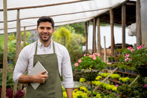 istock Happy man working at a garden center and using a digital tablet 1514147200