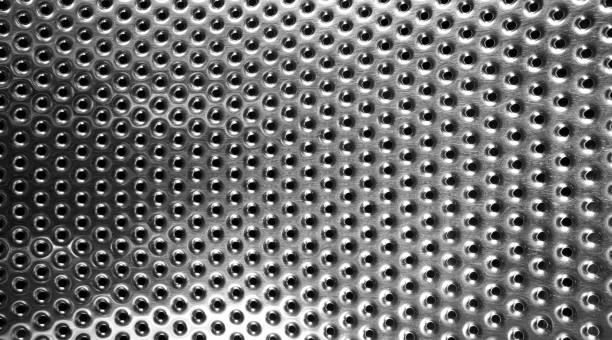 istock Washing machine drum interior. Perforated stainless steel drum for automatic washing machine. Black and white, metallic background 1514149377