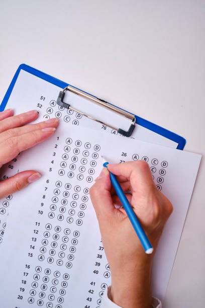 Admission test. Examination form. Choosing the correct answer. A sheet of paper with a test task. School exam. University quiz. Right or wrong option. Student to study. Elementary school question. Scoring and result
