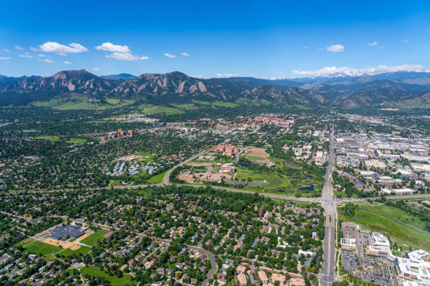 Aerial View above Boulder Colorado looking west at the Flatiron mountains, University of Colorado and the intersection of Arapahoe Ave and Foothills Parkway. Aerial photo above Boulder Colorado on a clear day looking west at the Flatiron mountains, University of Colorado and the intersection of Arapahoe Ave and Foothills Parkway. foothills parkway photos stock pictures, royalty-free photos & images