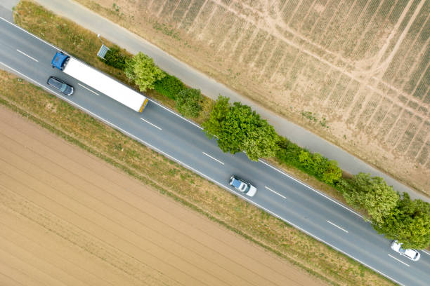 istock Aerial view over harvested wheat fields and country road 1514178540