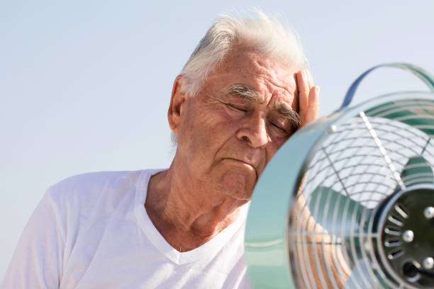 istock Elderly Man with Fan 1514178638