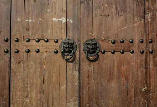Vintage door knob on old wooden door.