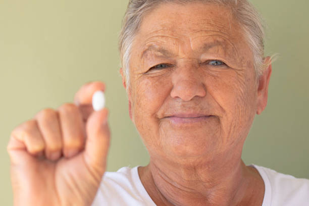 istock Woman Showing Pill 1514185561